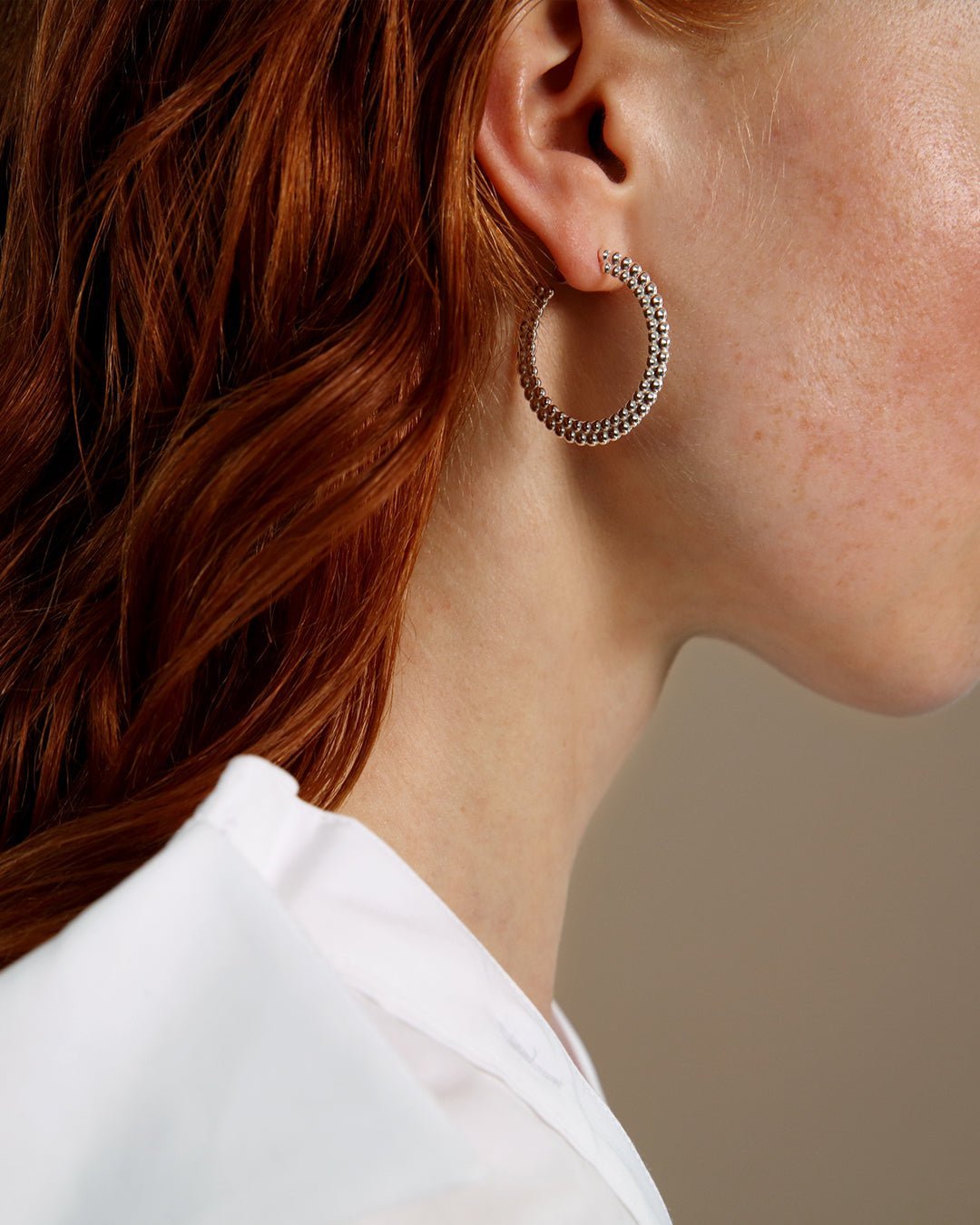 Circle of Light big hoop Earrings silver half pair left