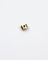 The back stud of the earring gold